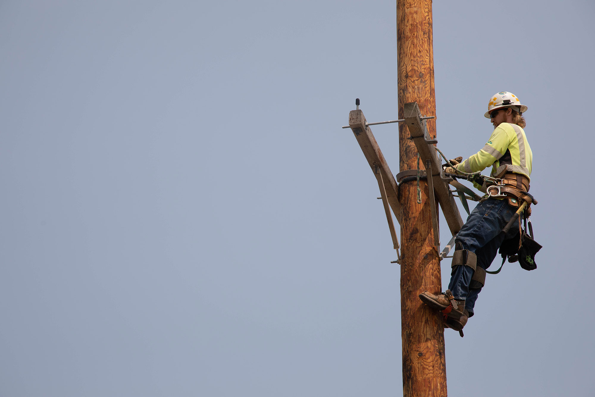 Line worker training on a pole.