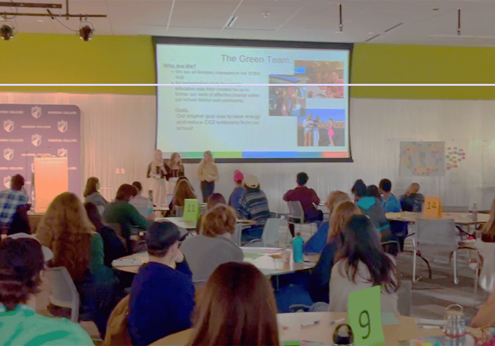 Members of MGE's Residential and Customer Service team talking to a room of students at the 2023 Youth Climate Conference.