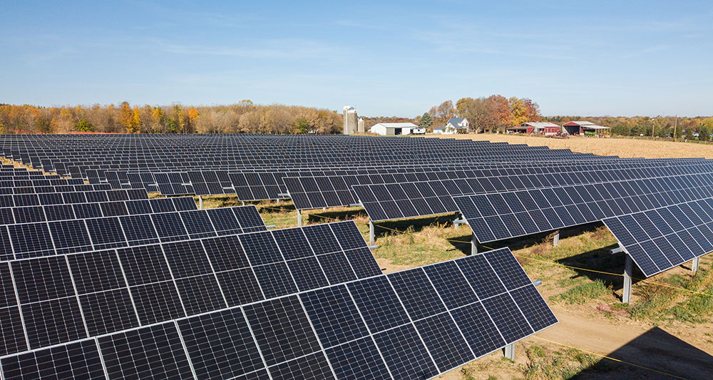 Solar array with fall foliage in the background at Strix Solar in Fitchburg