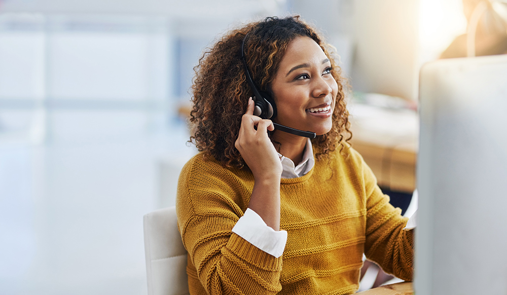 Account representative assisting a customer on the phone.