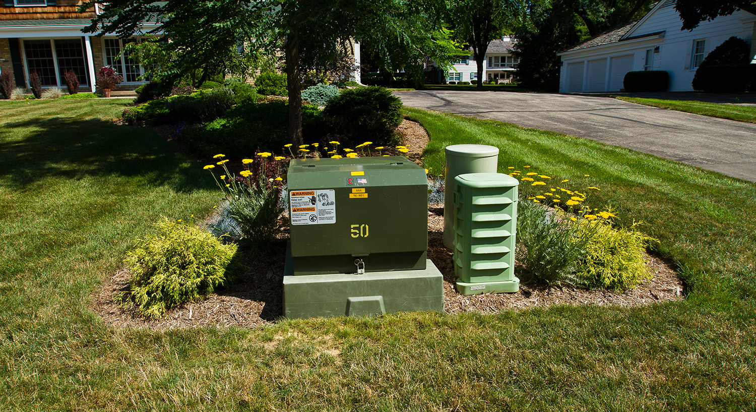 Landscaping around a transformer and pedestals.