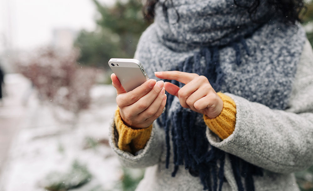 Using a mobile phone outside during winter.