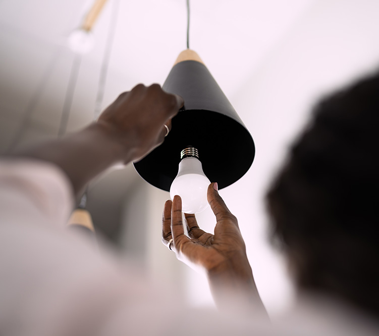 Replacing an LED bulb in a light fixture.