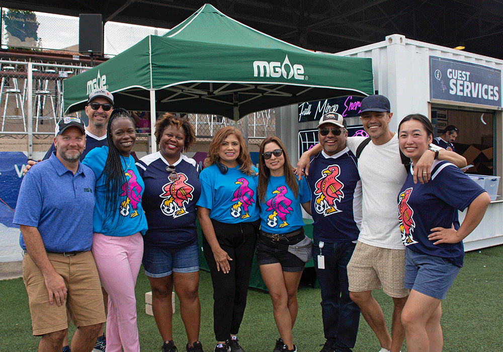 Members of MGE staff, along with Lupita Montoto of La Movida Radio.