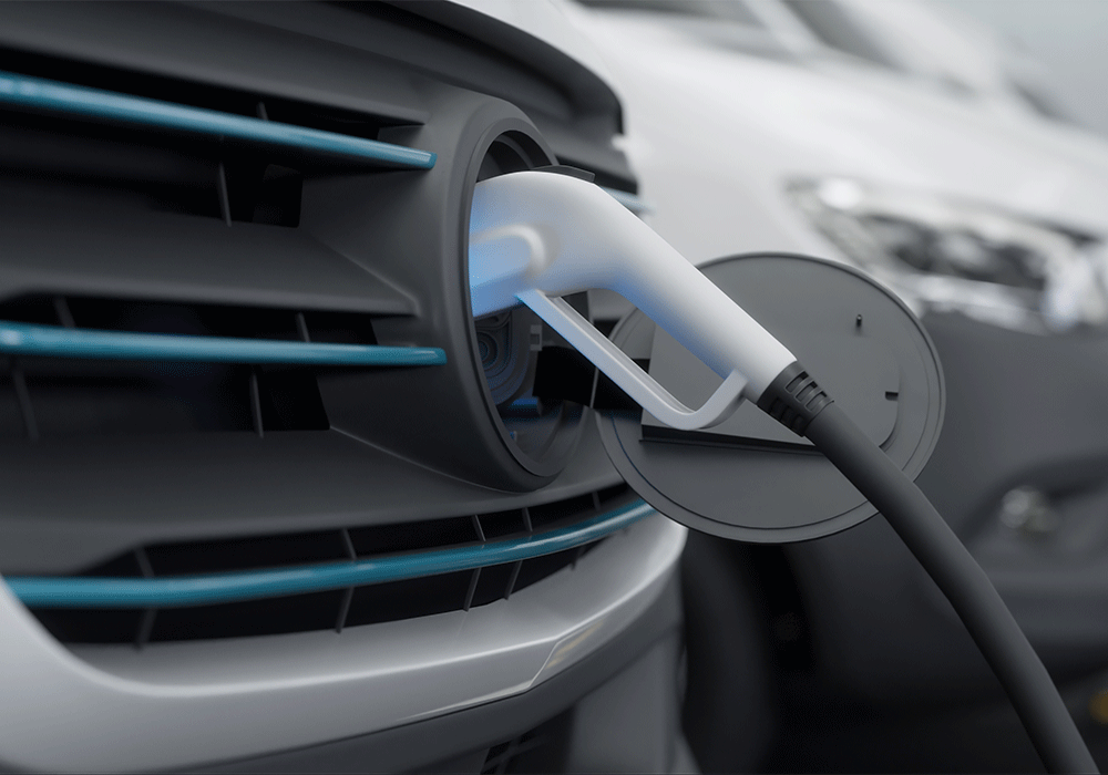 Close up of electric vehicle plugged in.