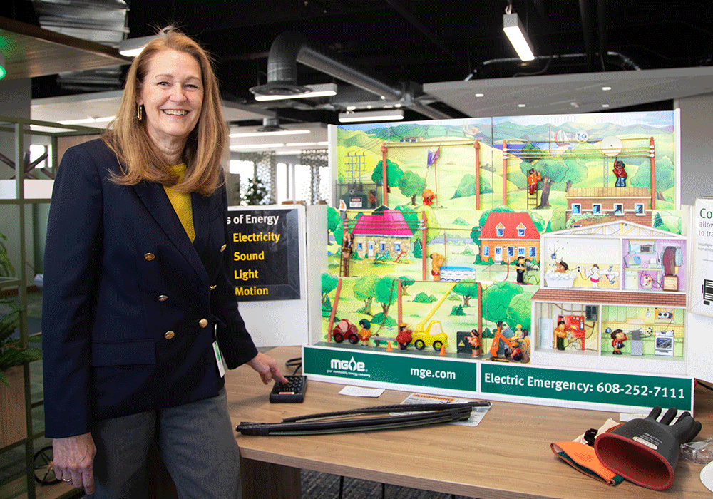 Flossie Baryenbruch stands in front of Hazard Hamlet, an energized tabletop city that demonstrates electric safety scenarios.