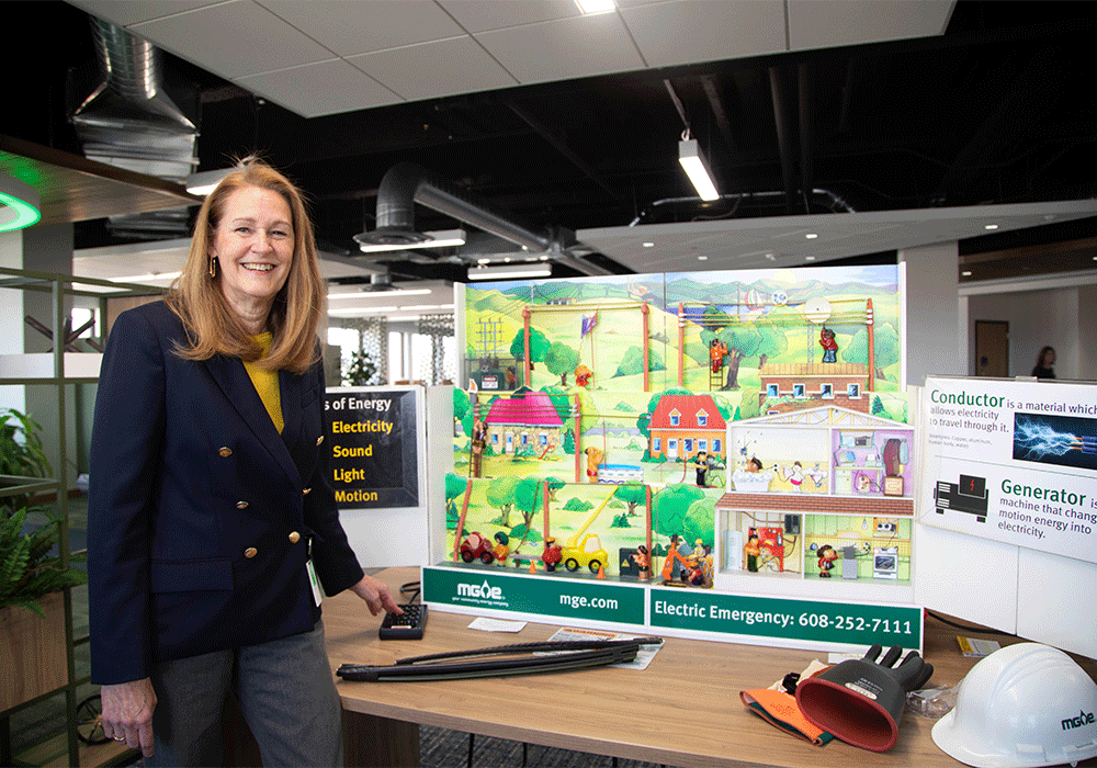 A woman, Flossie Baryenbruch, standing at a table prepared to teach about safety.