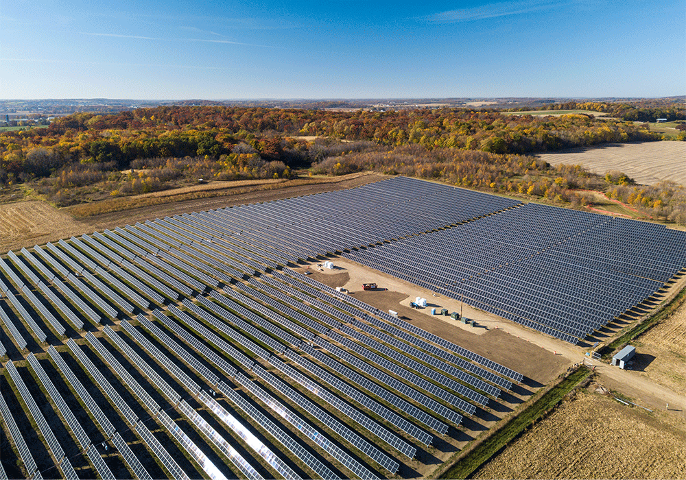 An arial view of dozens of solar panels on a sunny day at Strix Solar in Fitchburg.